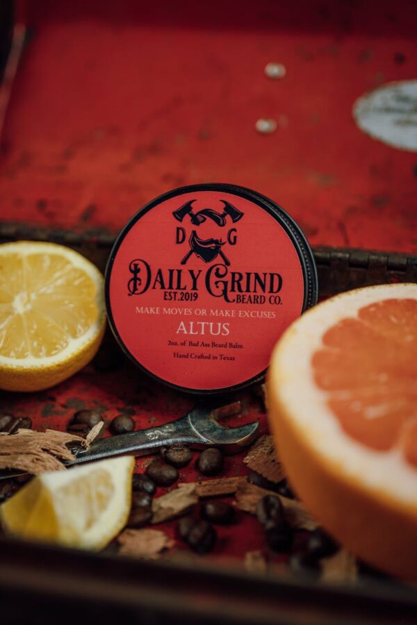 Beard balm with citrus and coffee beans for grooming and skincare.