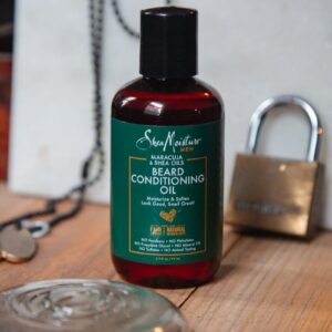 Beard conditioning oil bottle displayed on rustic wooden background.